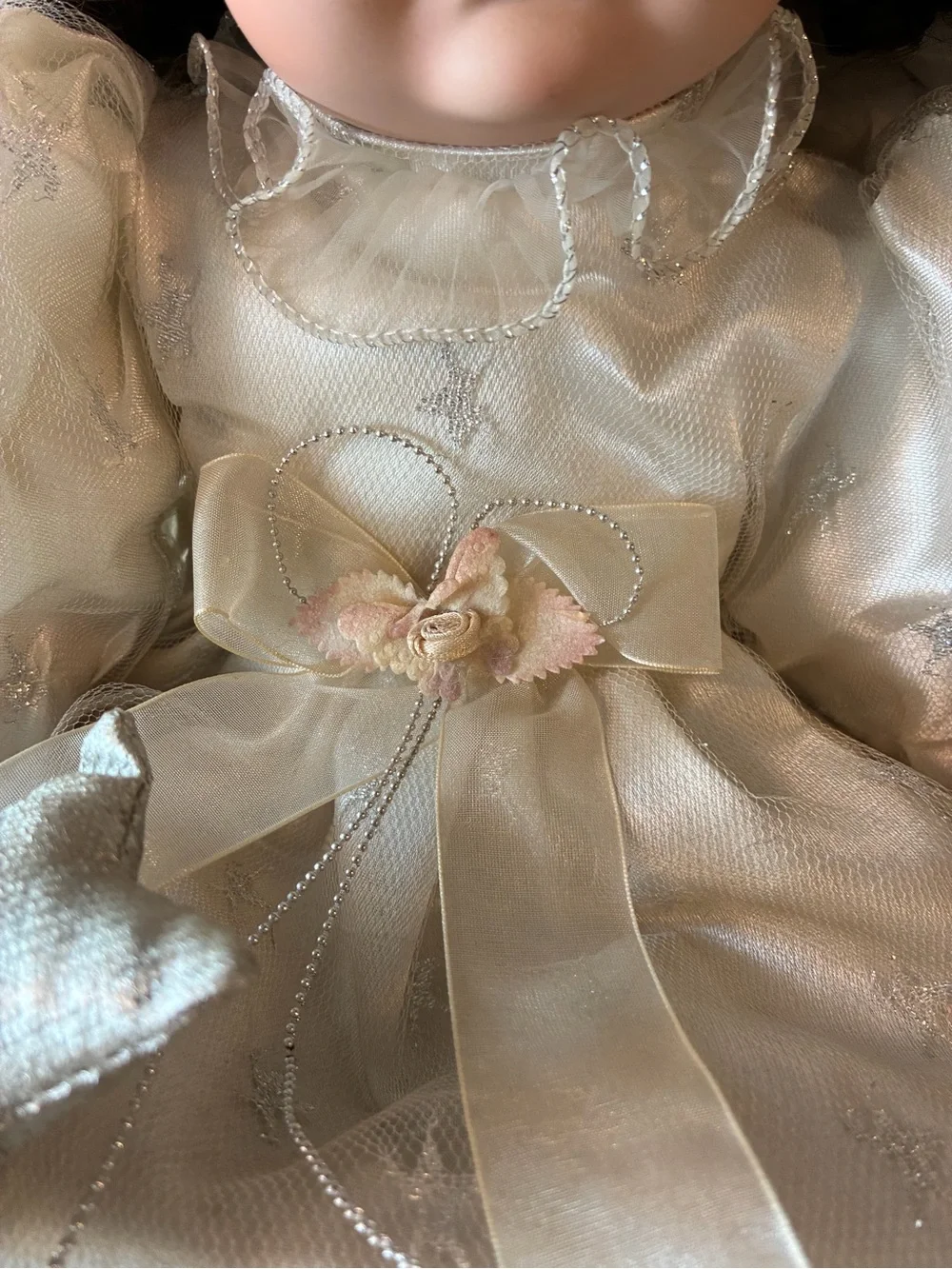 Vintage porcelain doll holding wand and wearing halo